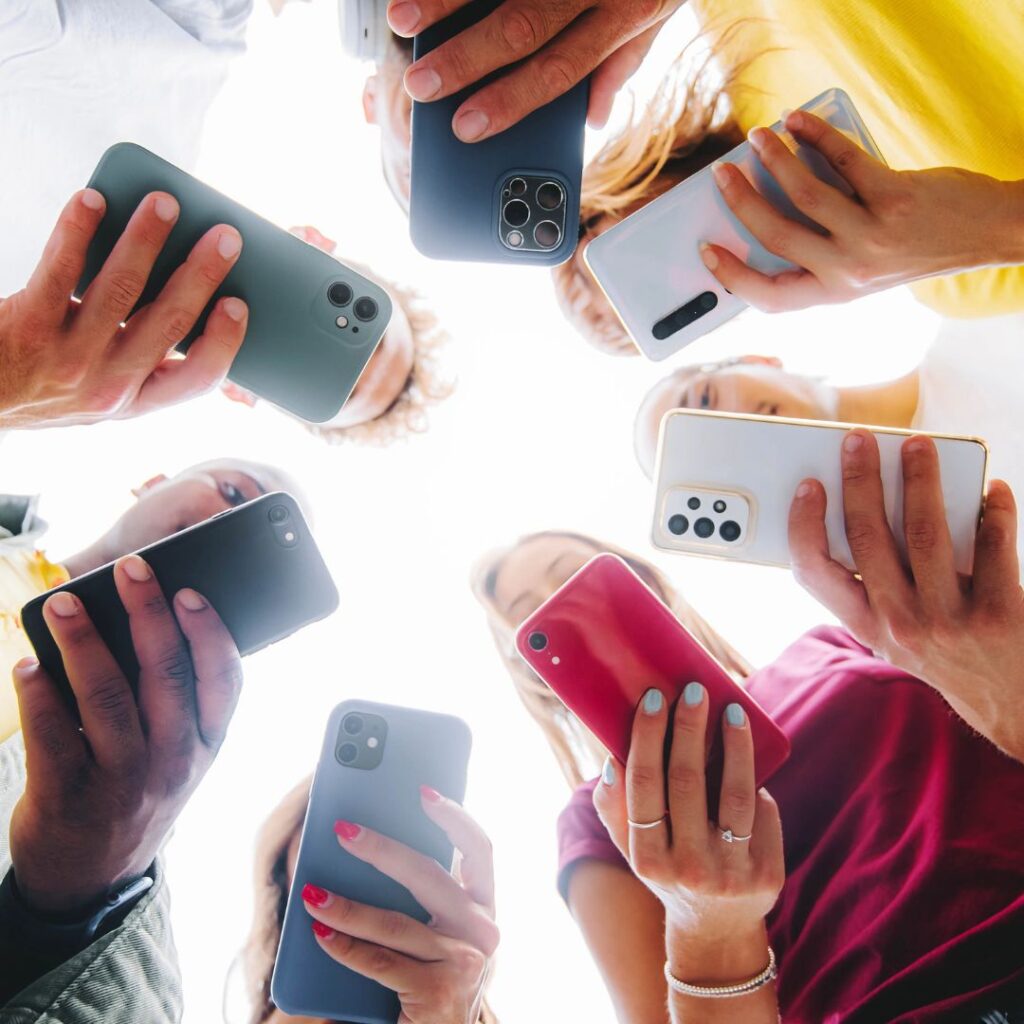 Reclaim your mind blog post image of teens holding phones in a circle