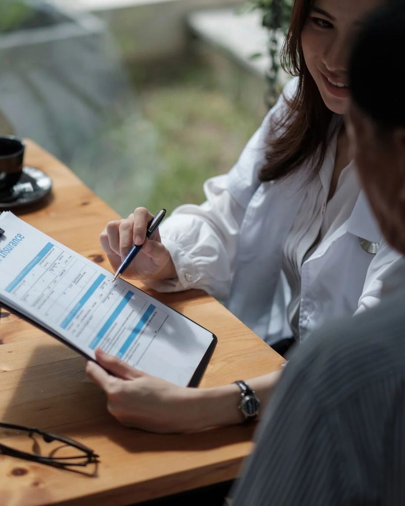 People reviewing health insurance form